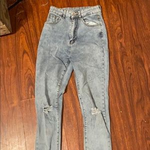 Light wash blue jeans ripped on the knees